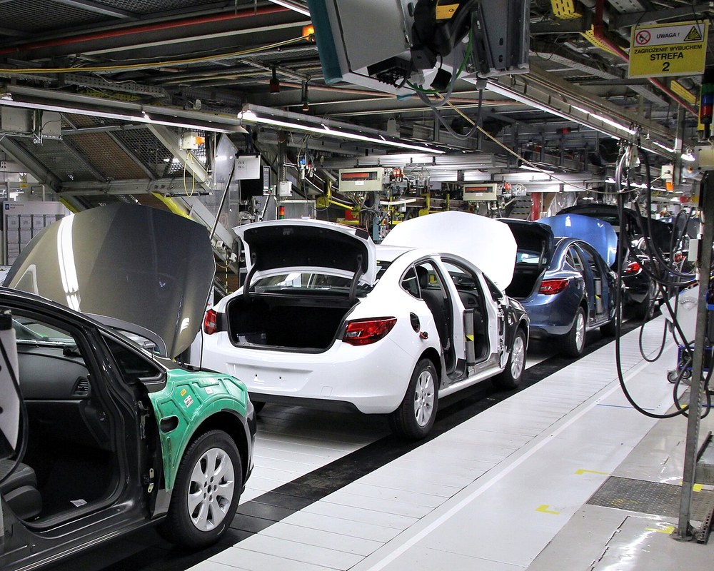 A vehicle assembly line — computer vision inspecting every unit, not just a sample