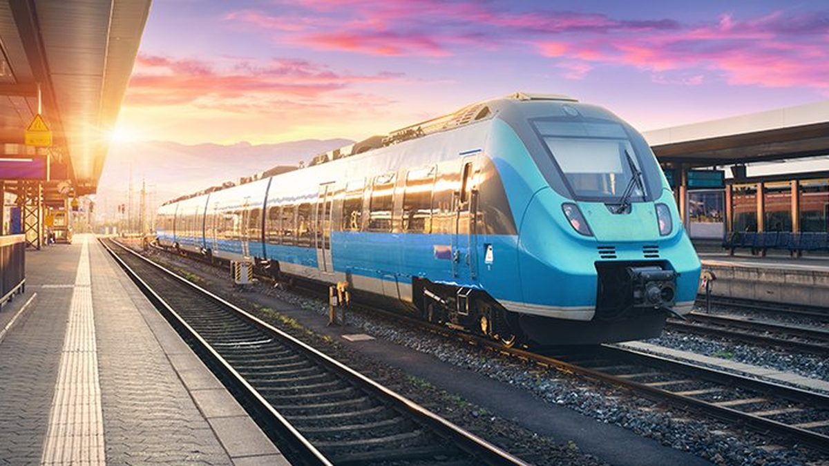 A modern train held to its rails at a station — guardrails keeping an autonomous system on track